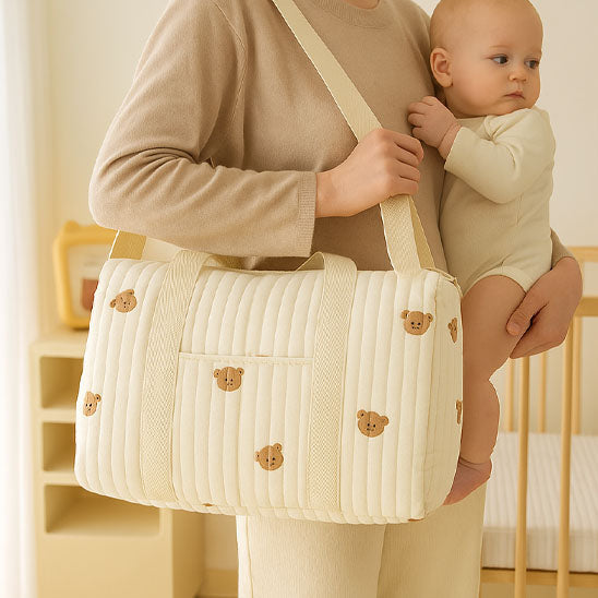 maman debout avec bebe vers elle sac a langer bebe sur l epaule