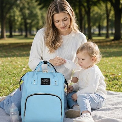 Sac a dos a langer bleu maman assis avec bébé